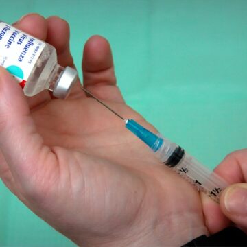 CDC / Unsplash Nurse drawing a vaccine dose from a vial
